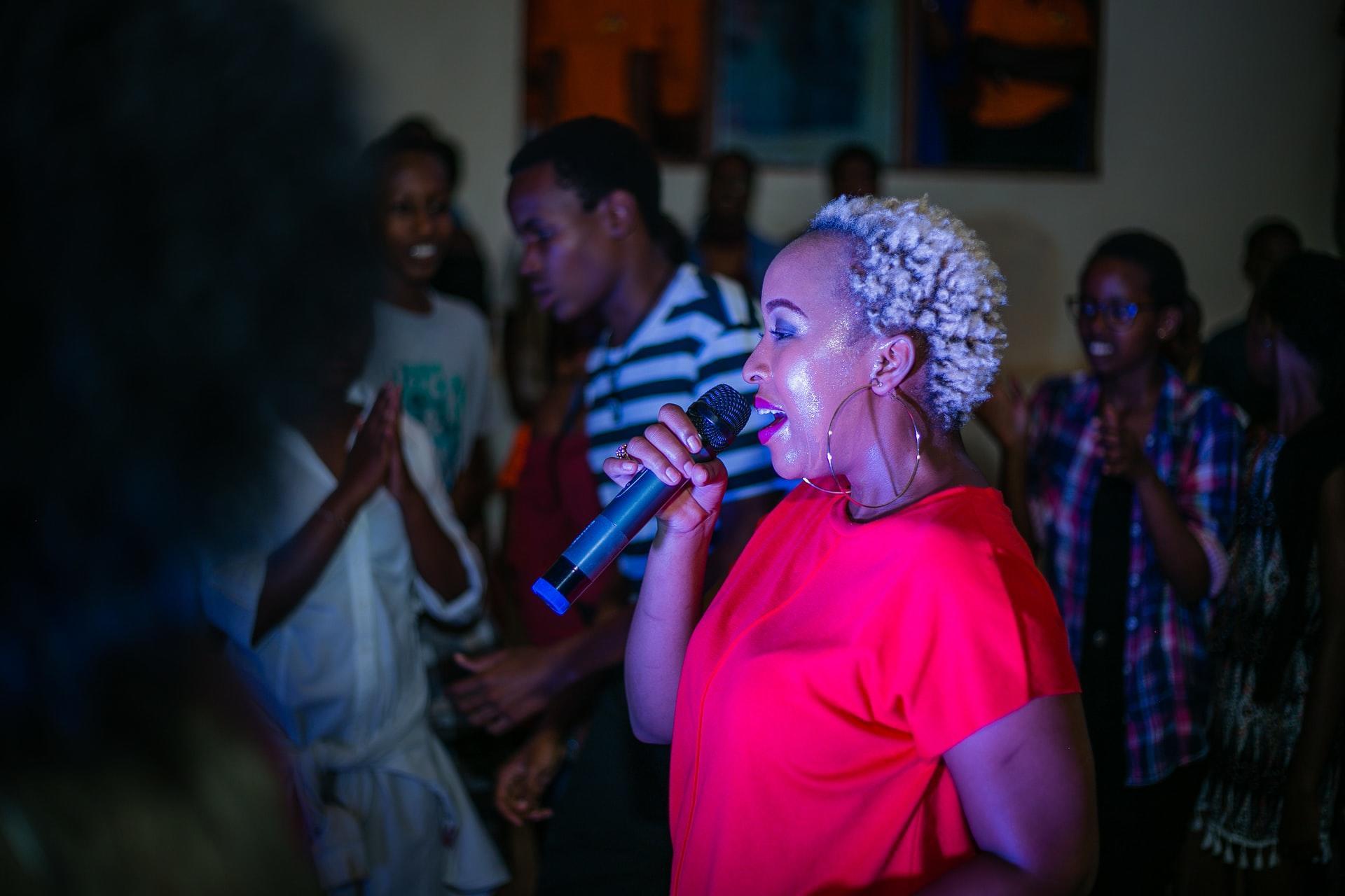 Women in pink shirt holding microphone