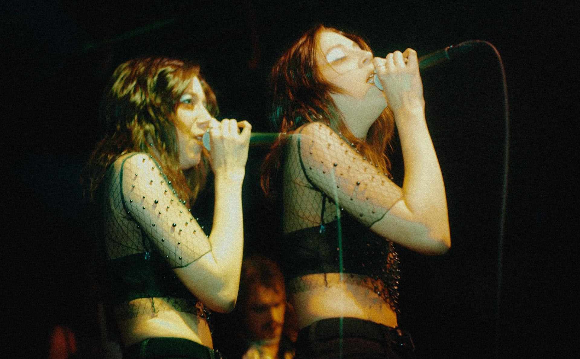 Two girls singing next to each other