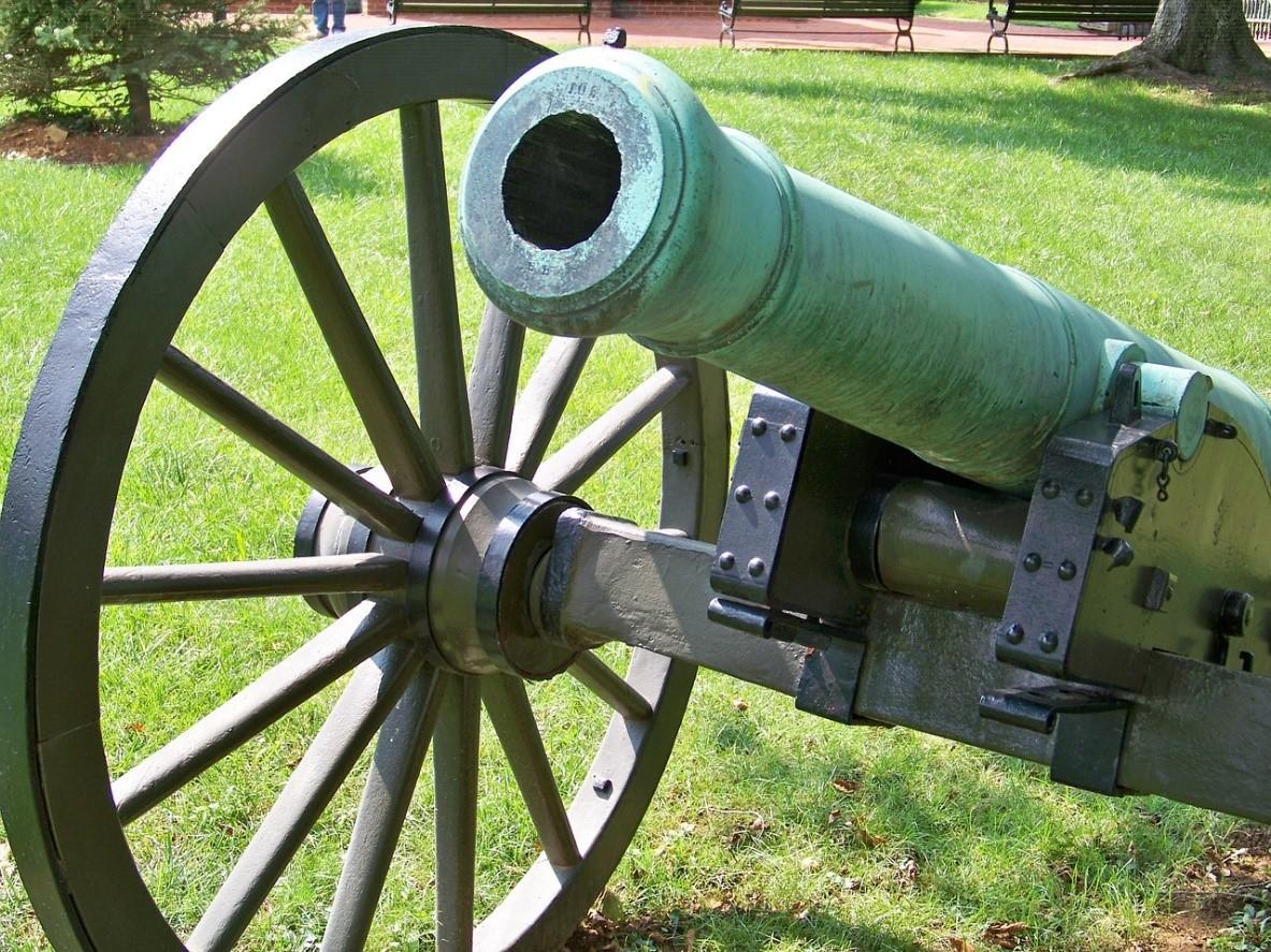 A green cannon in a field dated from around the American Civil War stored as an artifact. There are many Confederate and Union related remnants of the war that can be found in museums across the states