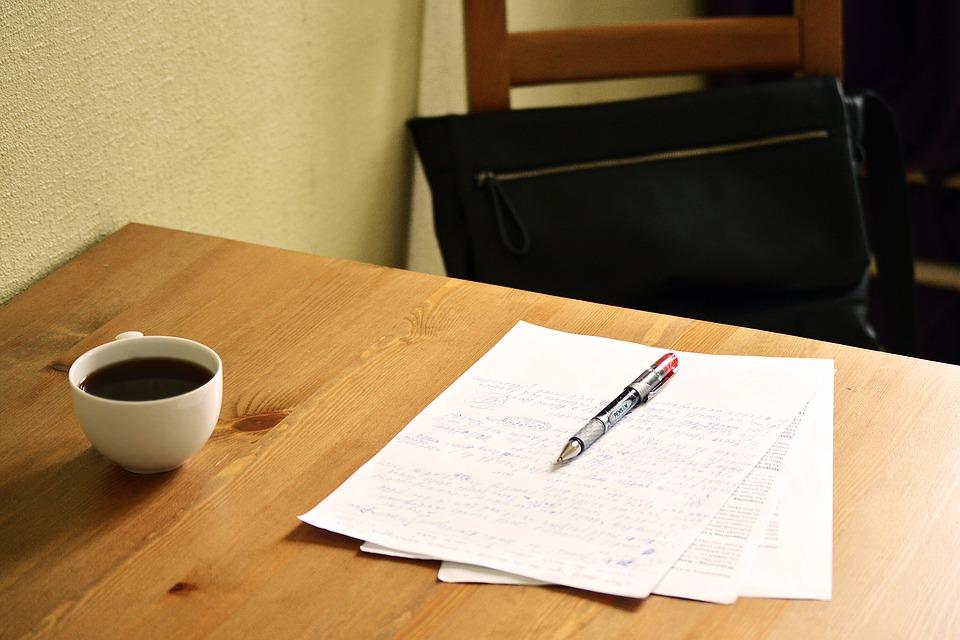 Notes and black coffee laid down on the wooden table with a bag in the background on the chair. It is better to be prepared for the ACT Test by practicing beforehand. And make sure that when you're practicing, there are no distractions!