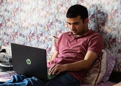 Nationwide lockdowns required all to stay indoors, and students were asked to practice distance learning. Here we see a student attending his online school while sitting comfortably on his bed and watching a video lecture