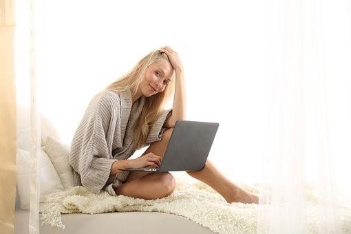 A girl sitting on her bed while attending video school. You are not compelled to change, freshen up or follow up on your regular morning routine; however, you should do so to stay efficient and maintain a sense of authority over your life