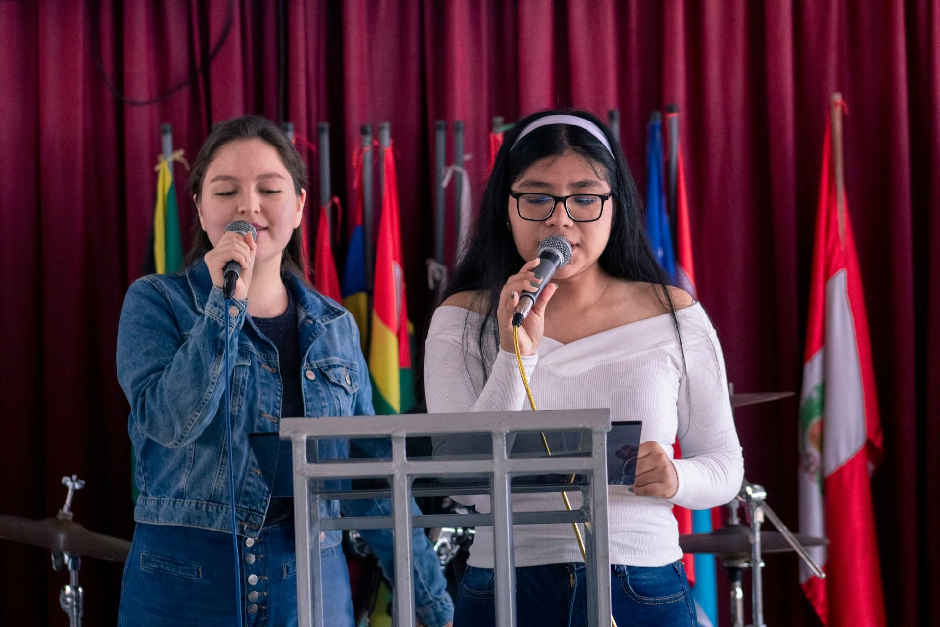 Two girls singing karaoke.