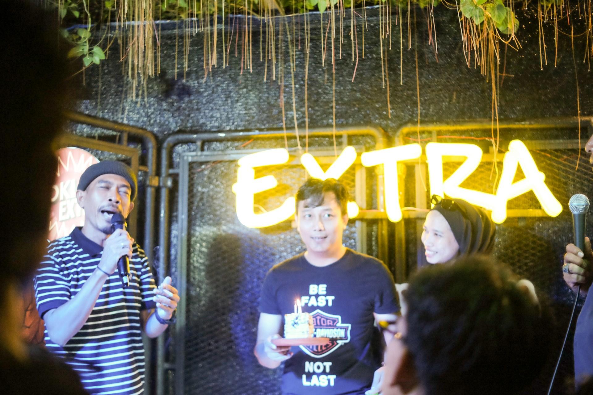 Some people participating in a karaoke night.
