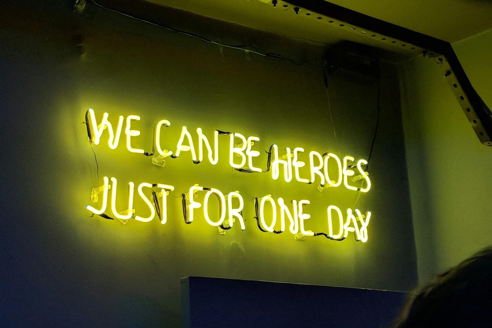 Lyrics from the song "Heroes" in a neon sign.