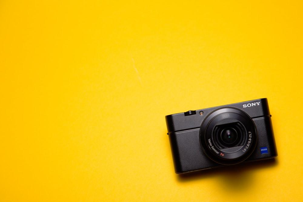 A black camera on a yellow surface; the importance of video/photo editing software has become more pronounced because everyone has a camera on their phone. However, Adobe After Effects is not an ideal program for video editing or creation, and it's best to use it in conjunction with other video programs