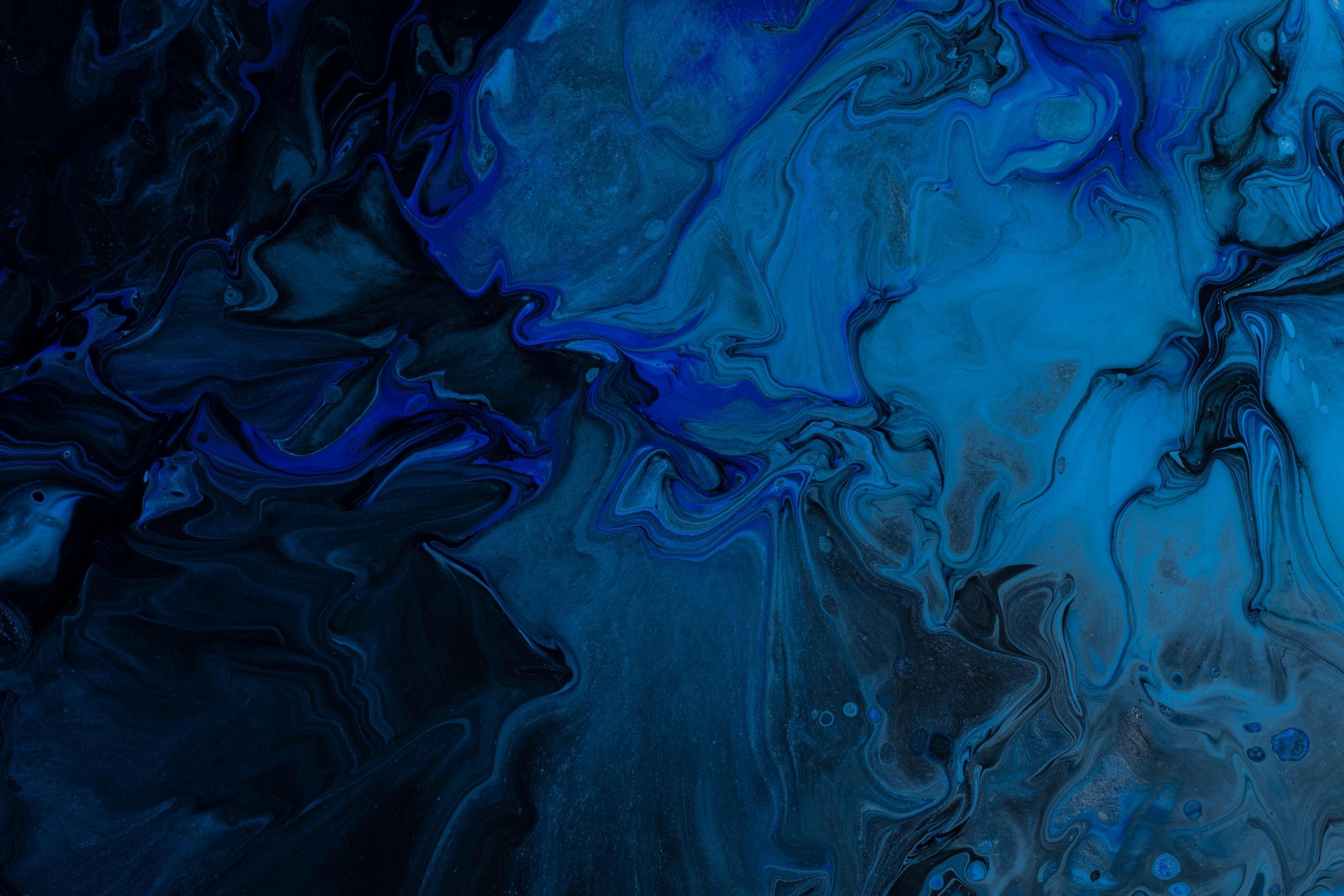 An abstract painting with different shades of blue, white, and black. An art student's range of work can vary differently, from working with paint to sculpting models with clay, and an art degree will only just enhance these skills
