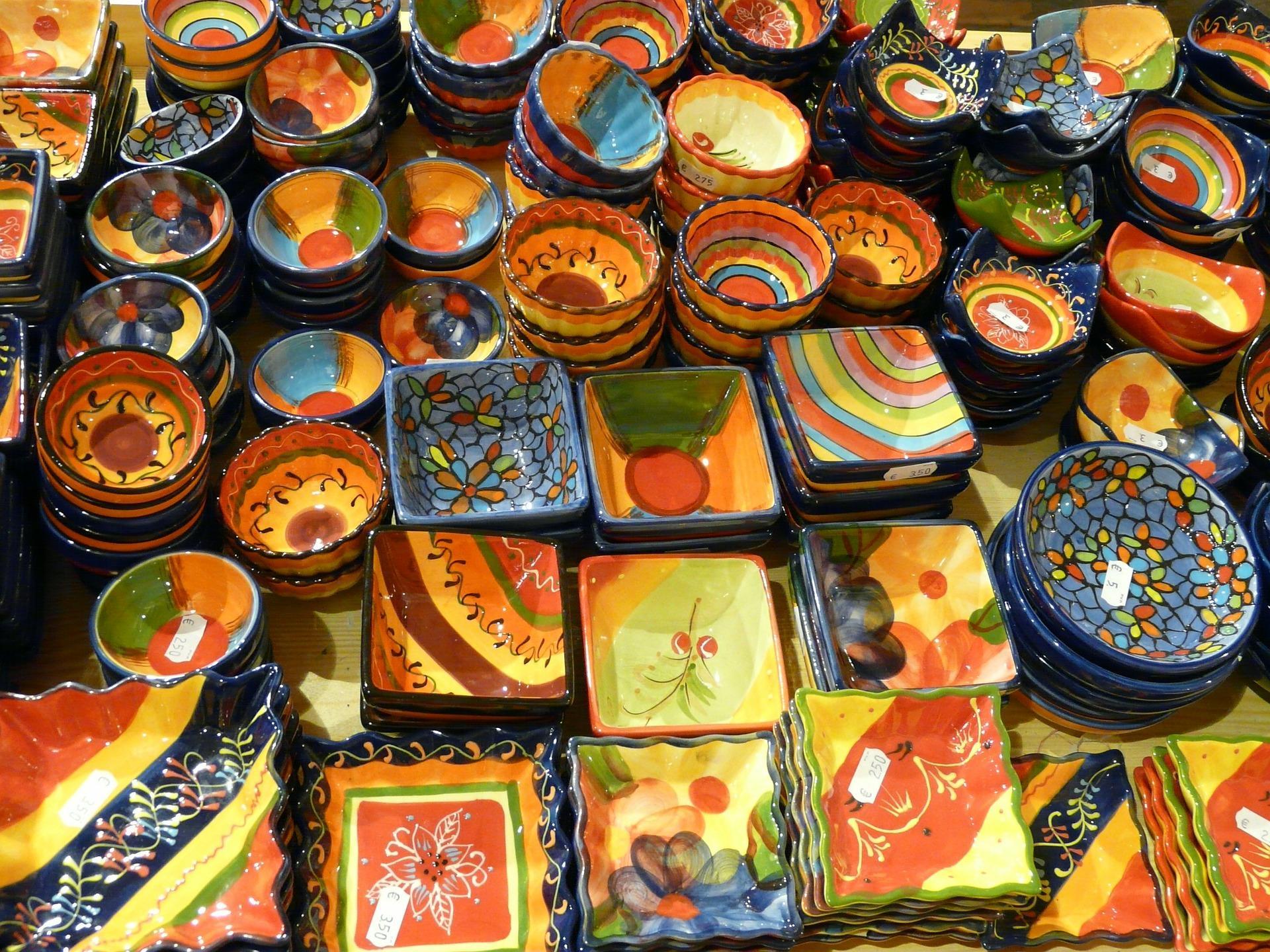 A vast collection of colorful pottery and ceramic arts displayed at a local antique pottery shop in the suburbs. Many such shops exist globally because pottery is appreciated in every country, regardless of economic, social, or traditional variables