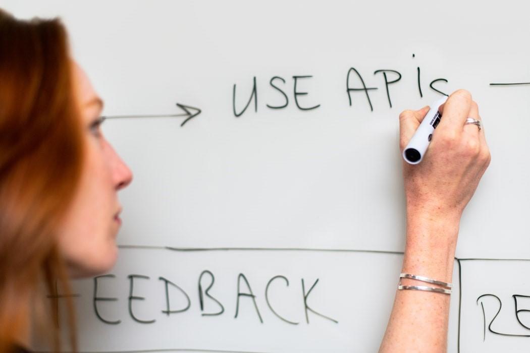 Teacher writing on a whiteboard. All students have different needs, and some may feel more comfortable learning computer programming face-to-face with concepts laid out on a board. Some students may feel a lot more comfortable just knowing online