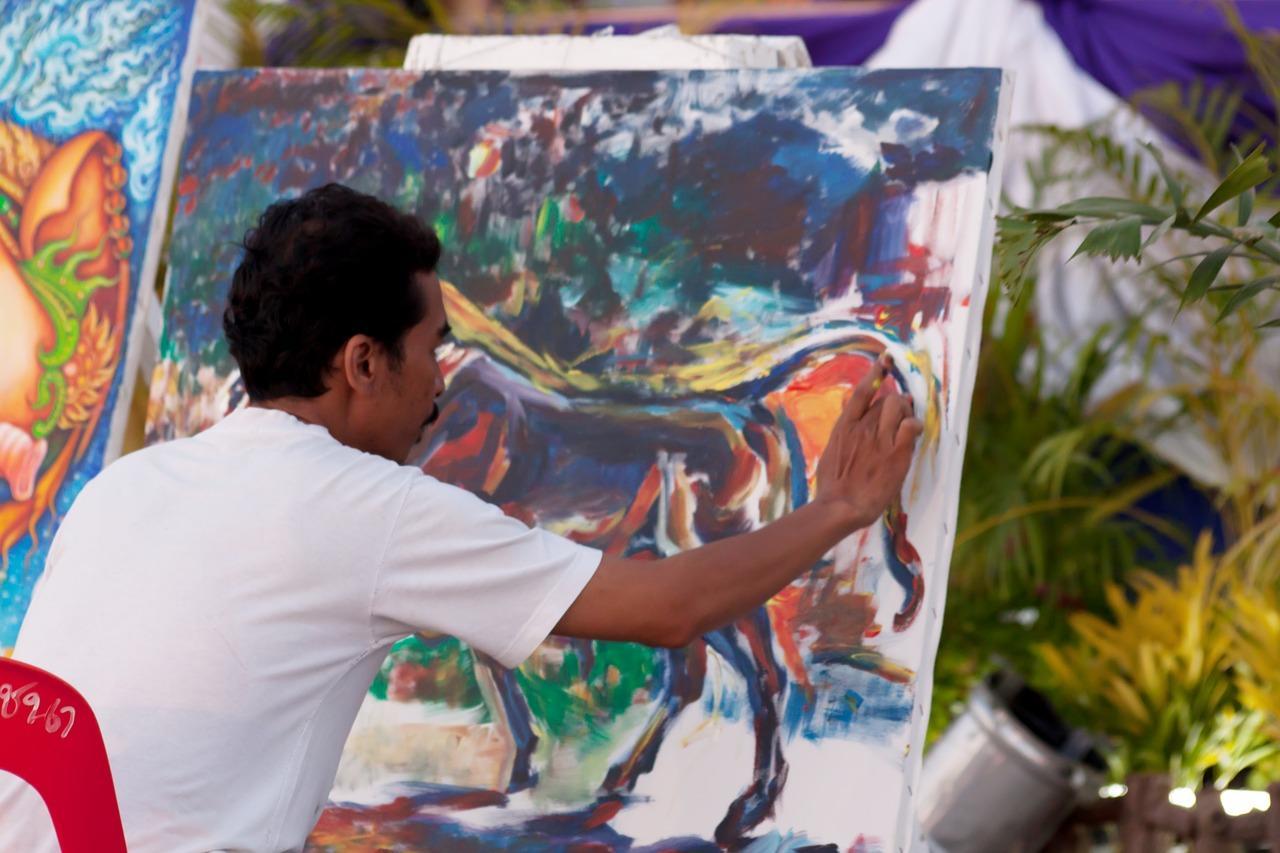 An artist is busy finger painting his next big project. Finger painting is a rare and unique talent. Though if you're curious to learn finger painting, you can enroll in an art school that teaches this technique in its curriculum