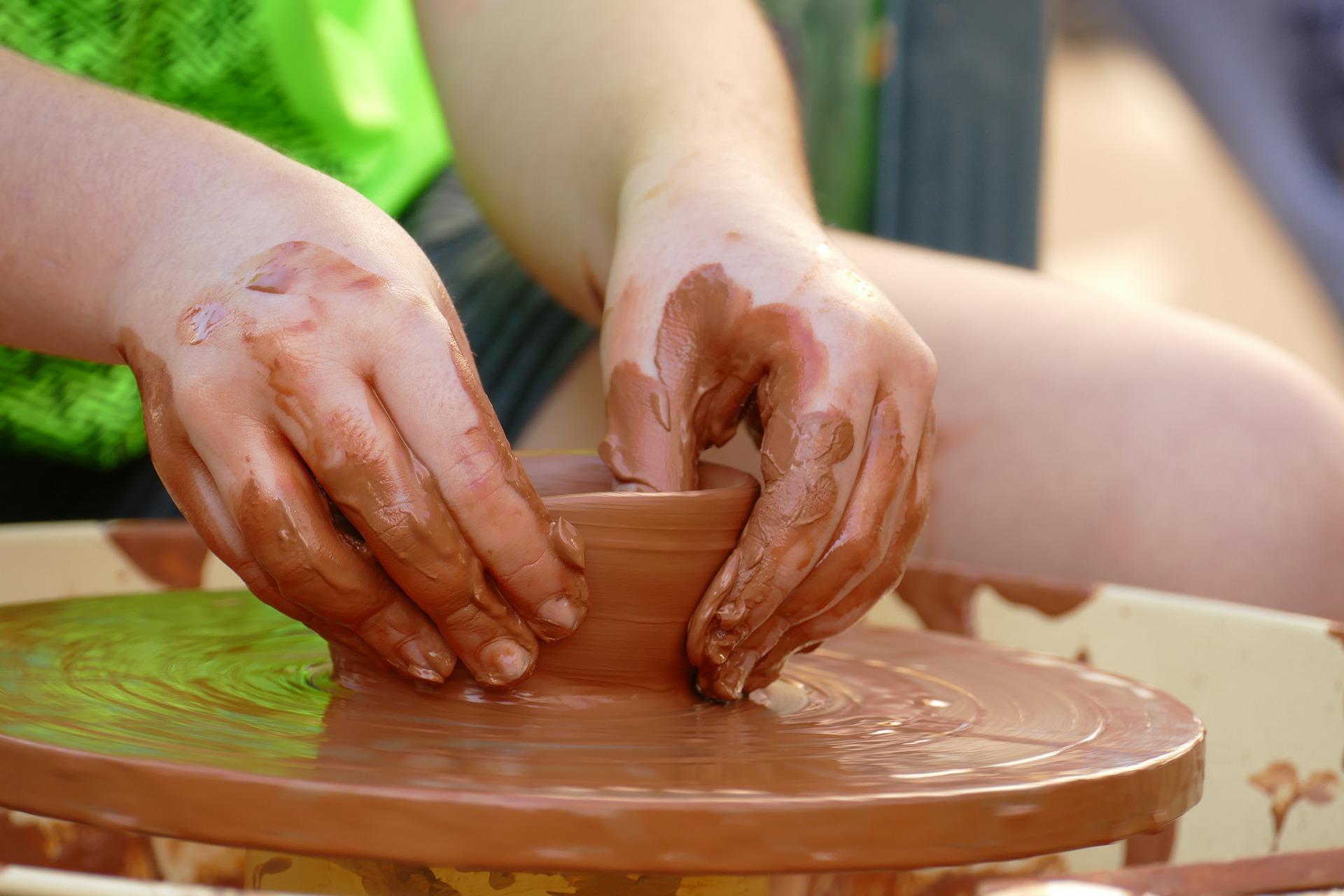 A student is seen playing with clay and making pottery using a pottery wheel. One of the many reasons you should take pottery lessons in the states is hands-on training and learning. Pottery is a skill that you hone over time, and you will need immense training to perfect it