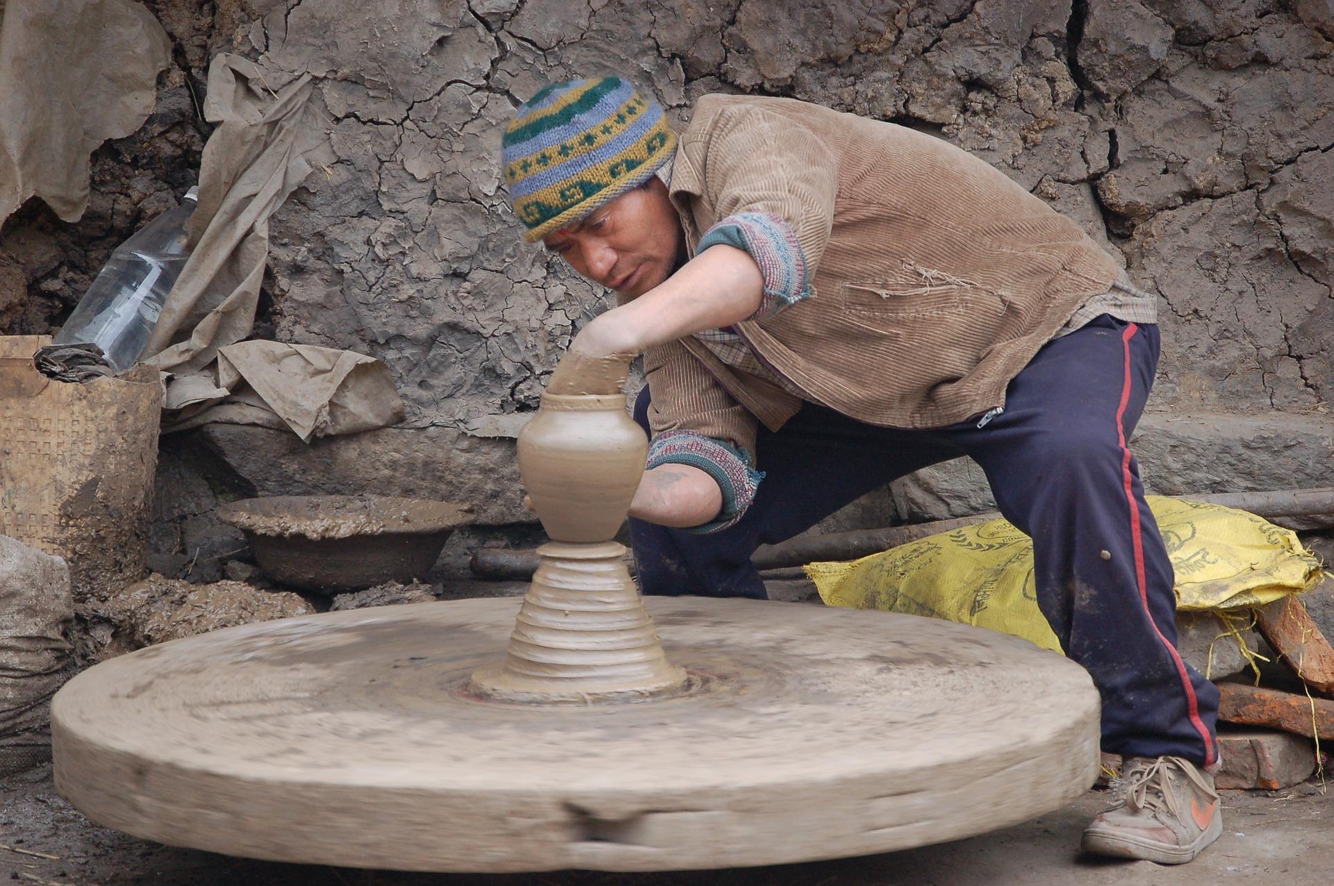 A person is seen carefully making pottery on a potter wheel. This art is one of the few disciplines that require undivided attention and concentration. One wrong move, and you would stand idly by as your clay piece flies off the spinner