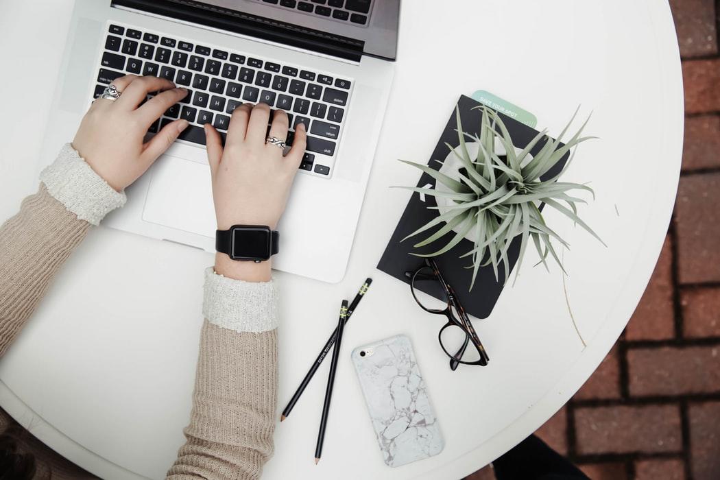 A person working on their laptop, with a notebook, pencils, phone, and glasses on the side. One of the best aspects of hiring private tutors is that you can get your lessons no matter where you are. There are so many tutors who you can easily find online who can help you get your computer programming degree