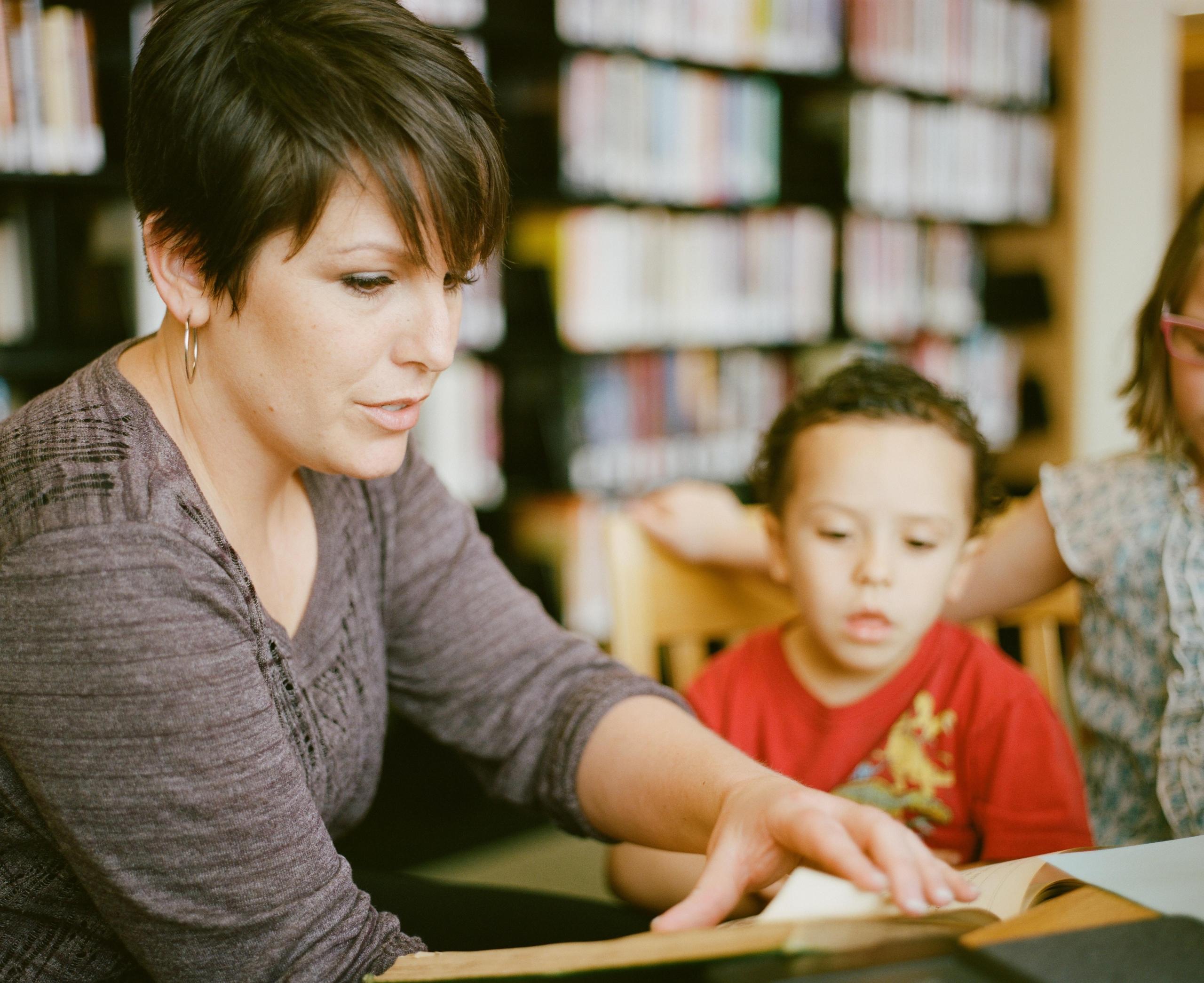 A female tutor is seen explaining to two kids at home how to solve a math problem they got for their homework. Tutoring helps your child learn new and more difficult concepts quickly, and if they like their tutor, they will also develop an affinity for the subject being taught!
