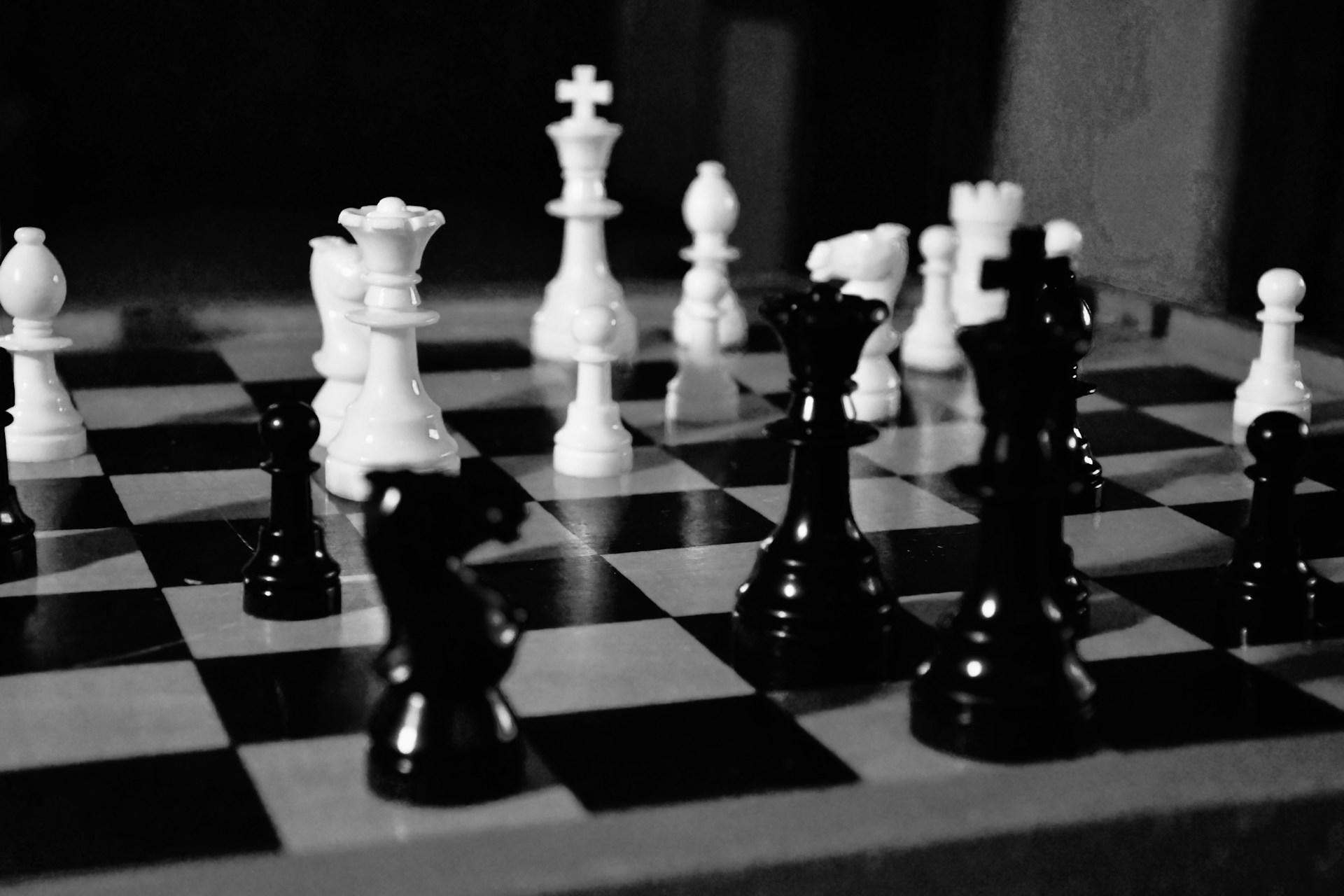 A black and white chess board and pieces.