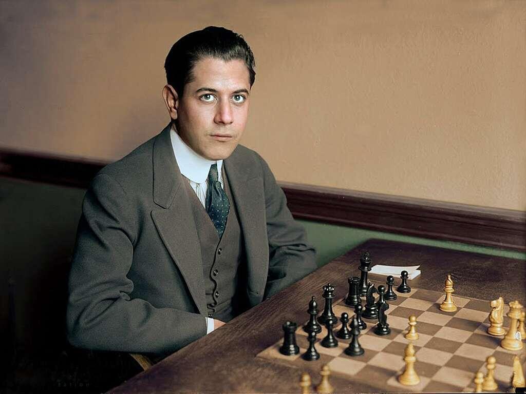 Jose Capablanca sitting in front of a chess board.