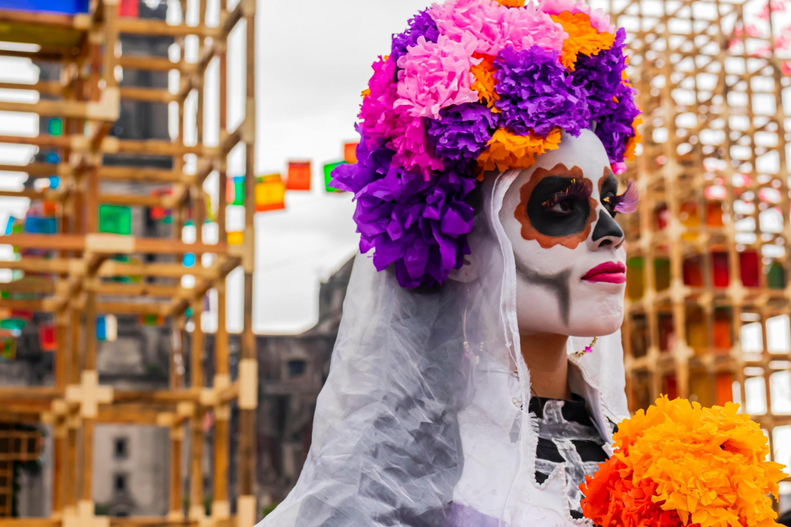 A lady is wearing paint to commemorate the Day of the Dead. Coco is an award-winning Mexican movie that takes a lot of inspiration from the Day of the Dead celebrations; it is also an animated feature, making it more appealing