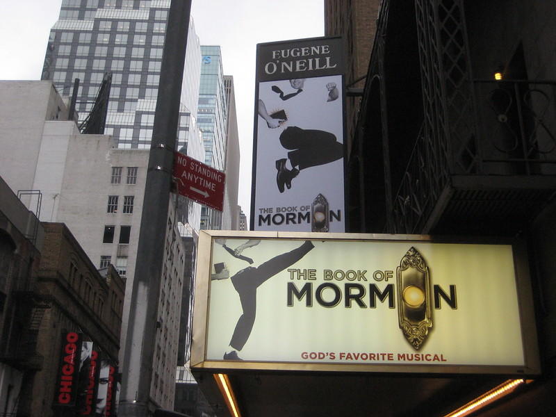 Boards advertising 'The Book of Mormon' at a theatre on Broadway. One of the boards reads: 'God's Favorite Musical,' because the musical is a satirical take on religion. This lax attitude towards religious discourse is only possible because of shows like The Book of Mormon