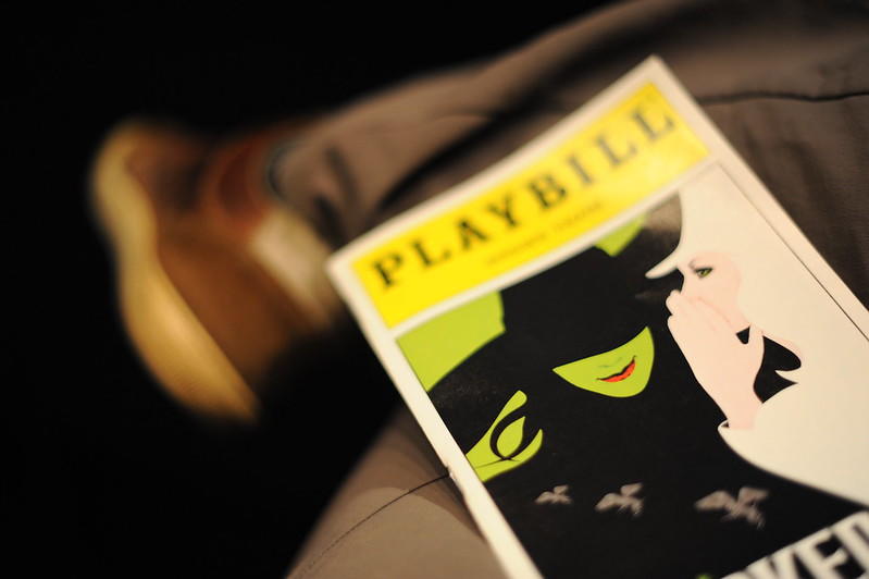 A playbill on a theatre goer’s lap. A playbill is a theatre program, sometimes also referred to as a poster advertising a play. They are commonly used to promote Broadway shows in New York and are also collected as memorabilia