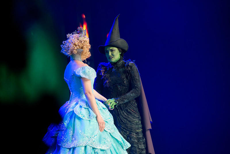 The two primary characters of Wicked are seen locked in an intense scene. Wicked wasn’t touted to become as famous as it did; however, it is now among the most famous Broadway shows of all time!