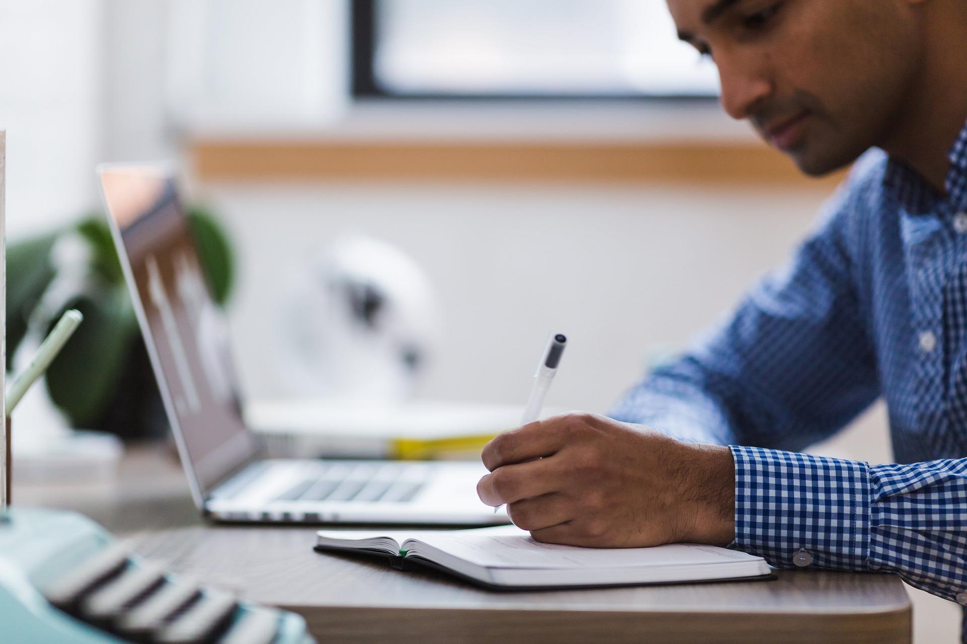 A man studying and making notes at his desk. AP French prep requires a lot of listening and absorption. If you are patient and open, you will be able to understand the material a lot easier