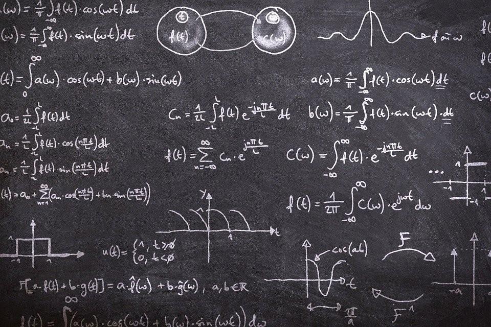 Different math concepts and workings on a blackboard 