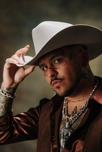 portrait of Christian Nodal with a cowboy hat