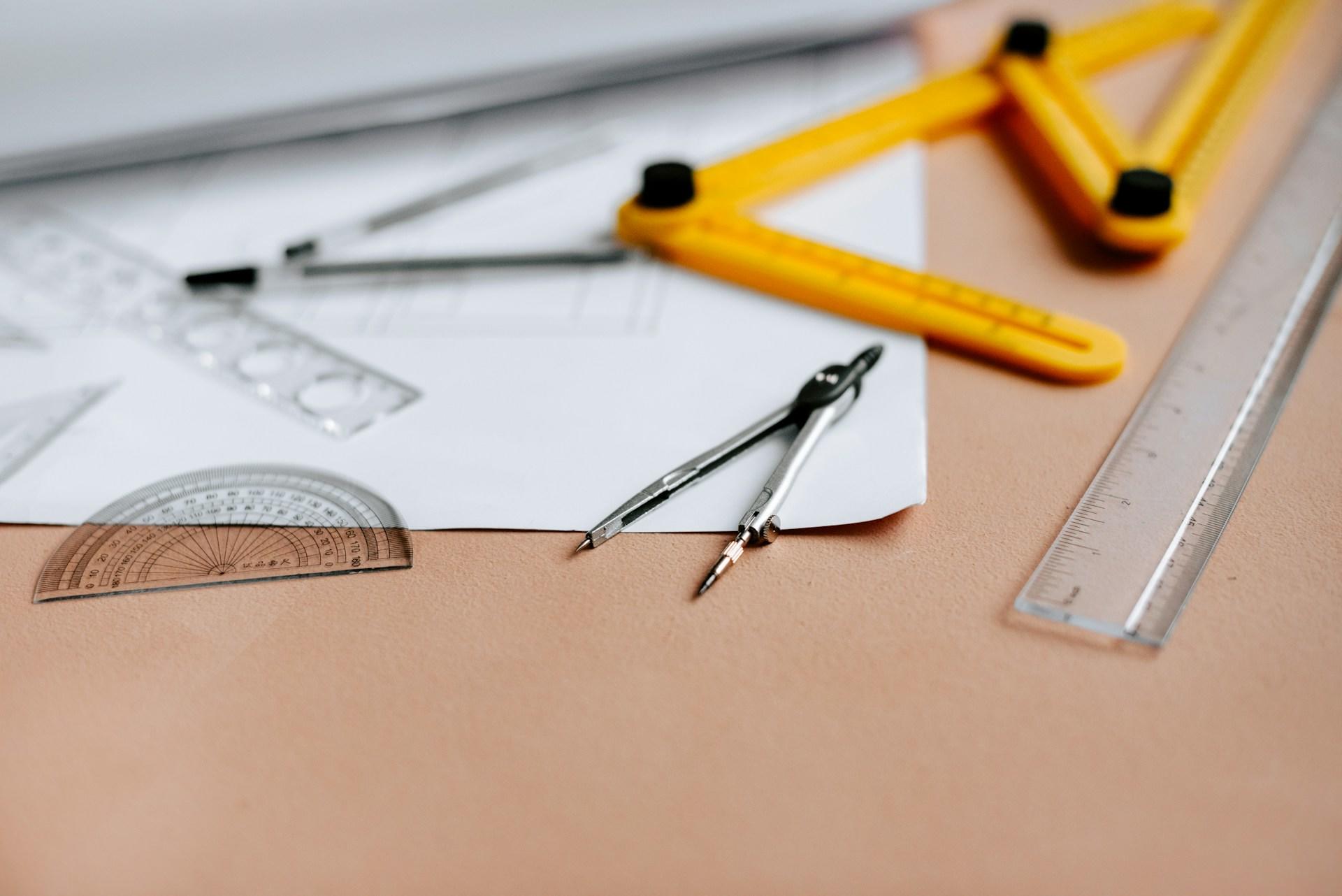 A ruler and different math equipment on a desk.