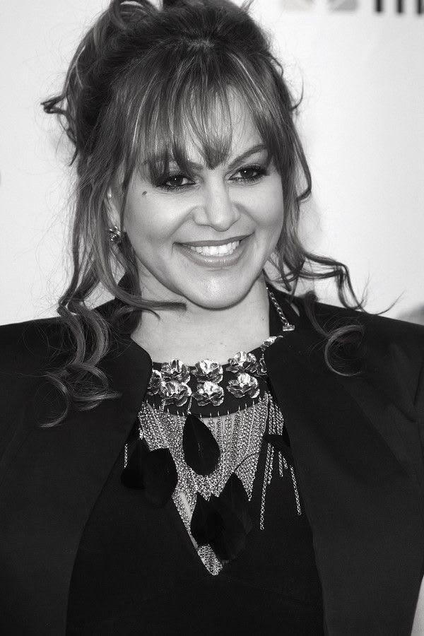 Jenni Rivera posing in a red carpet, black and white portrait