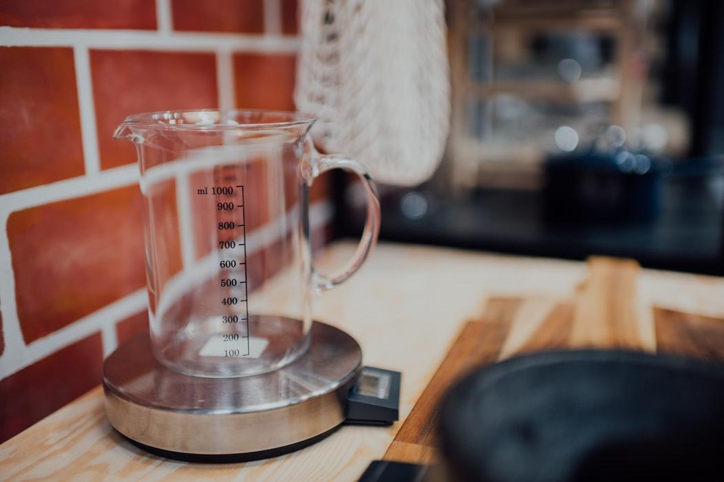 A measuring cup on a weighing scale