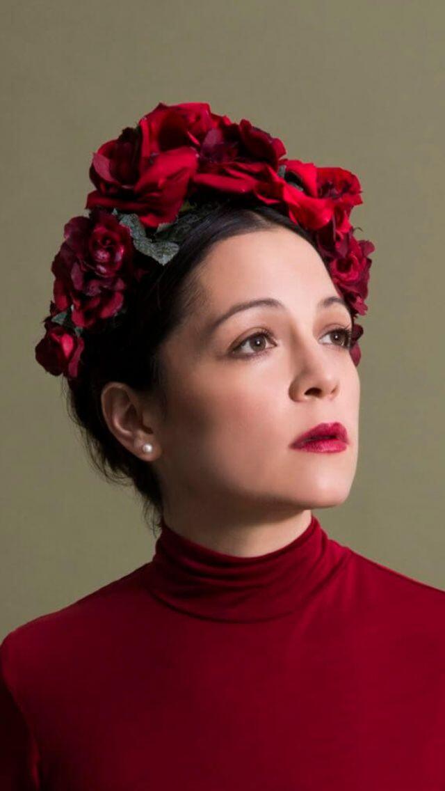 portrait of Natalia Lafourcade with a tiara made of red roses