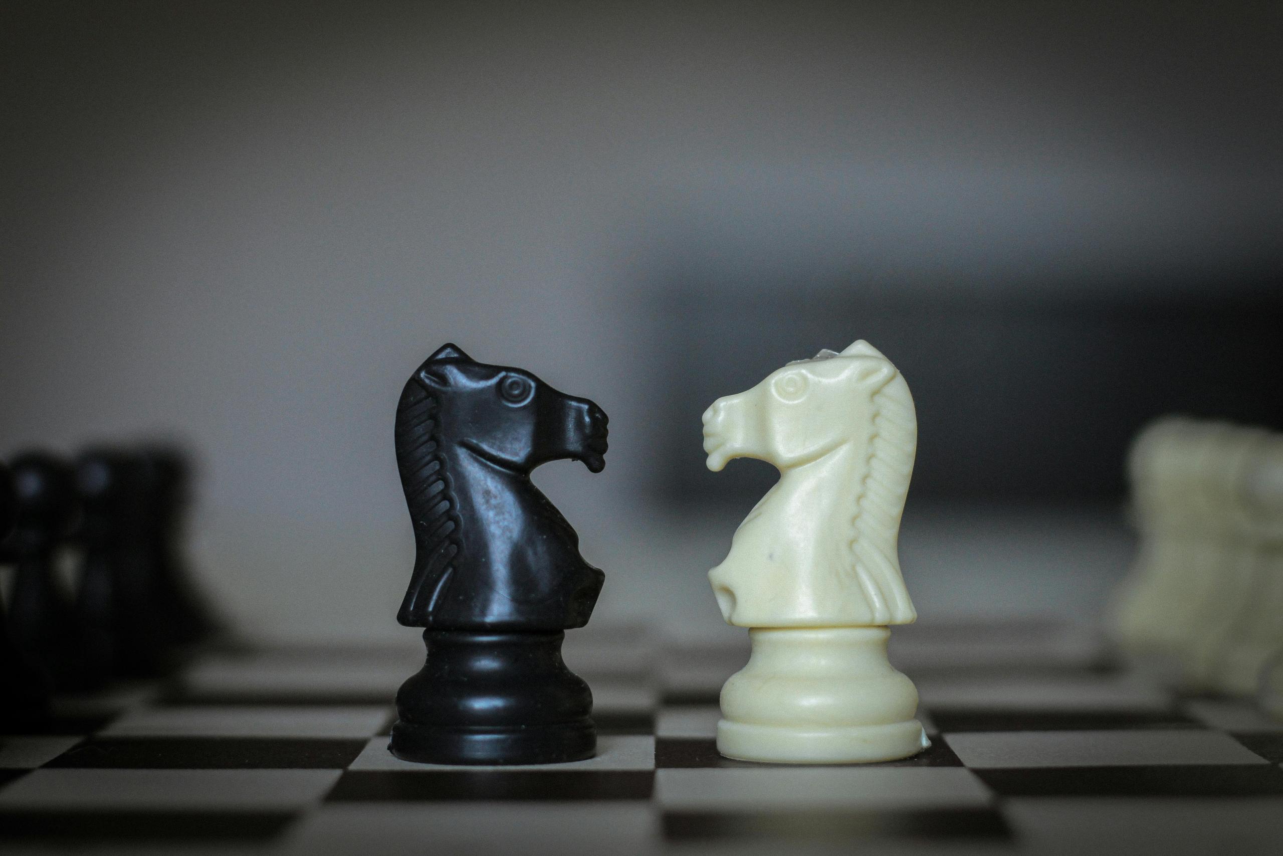 Two knights are faced on each other after having them one of the last remaining pieces in the game. 
