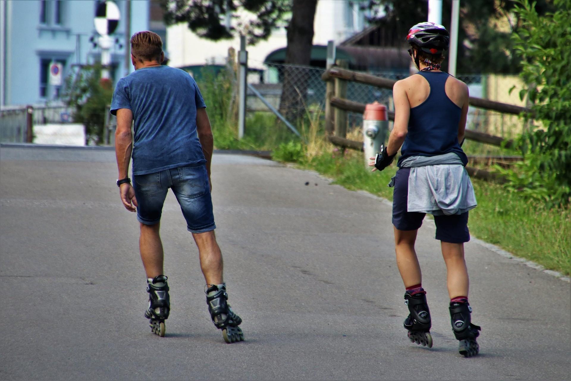 Two beginners are roller skating, having invested in the best outdoor roller skates for beginners
