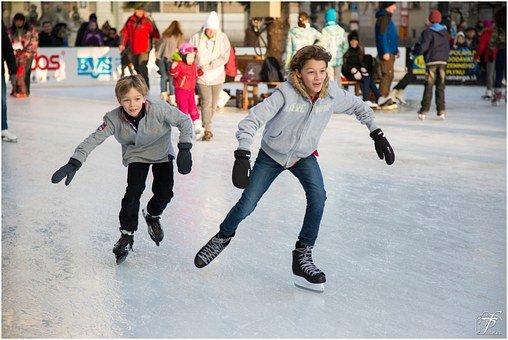 Two boys skating on ice
