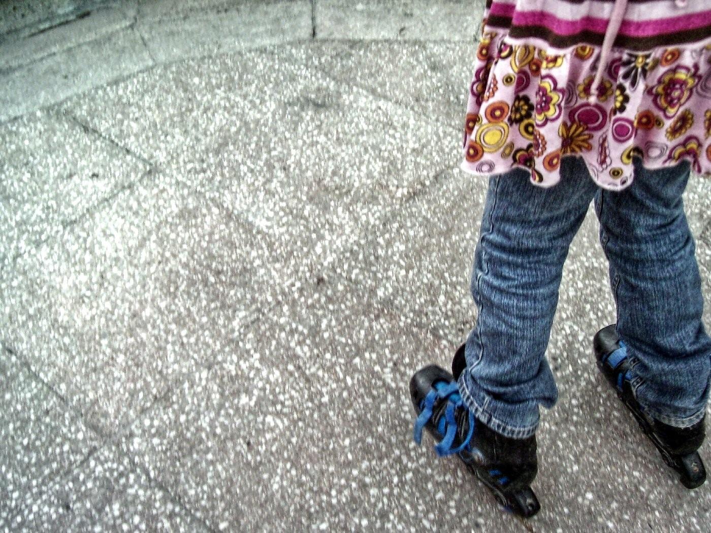 A young child manages to balance themselves on skates successfully