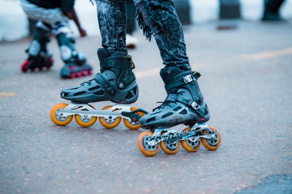 A person skating with a pair of racing skates