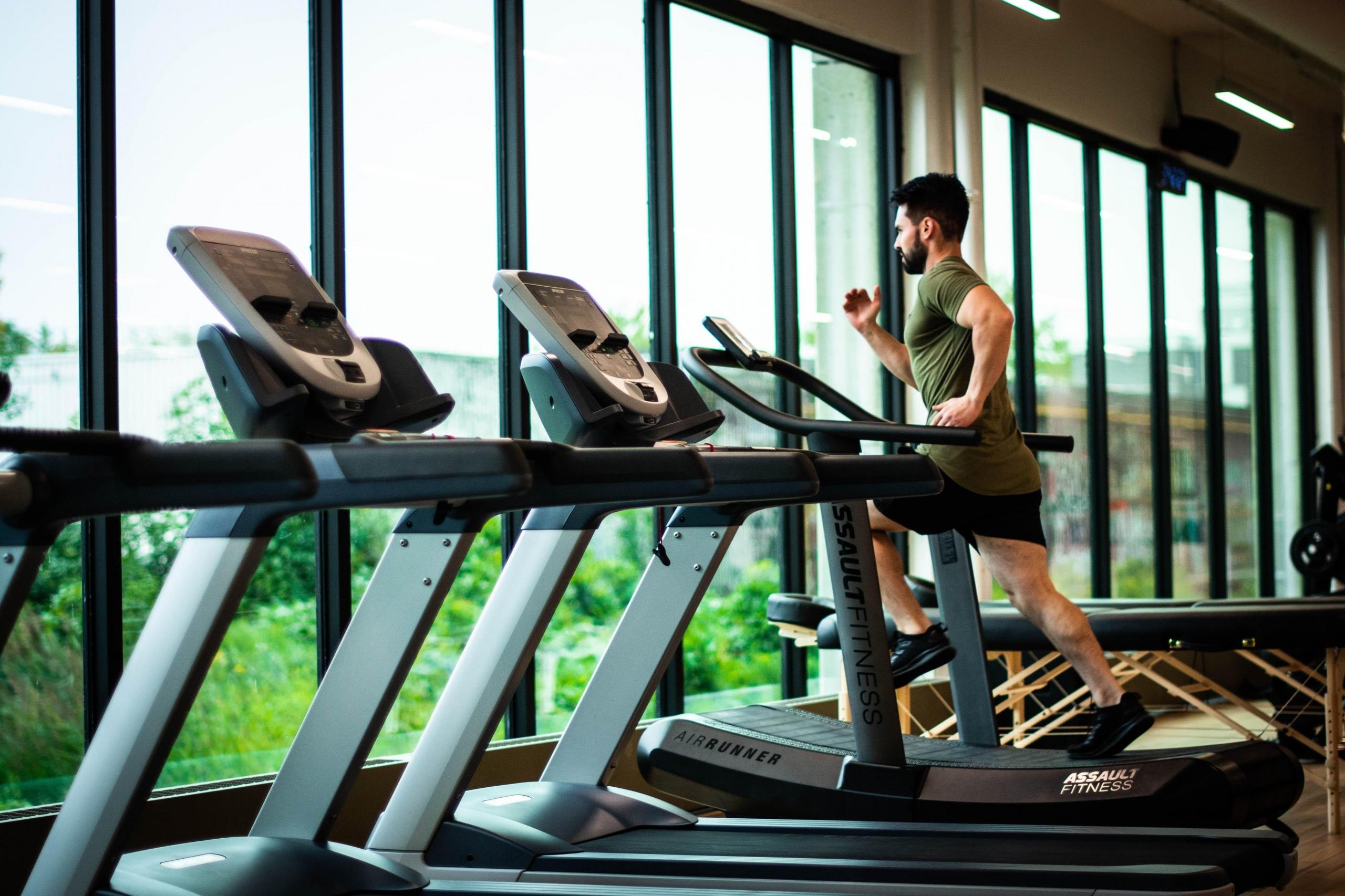 Man running on treadmill at gym