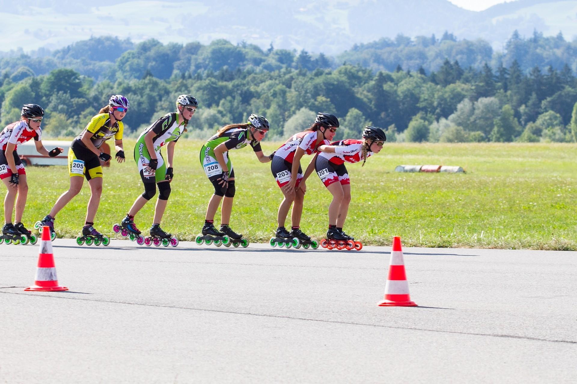 Competitive roller skaters are seen pacing themselves in a line