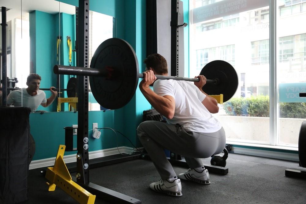 A gym-goer lifts weights during an intense workout