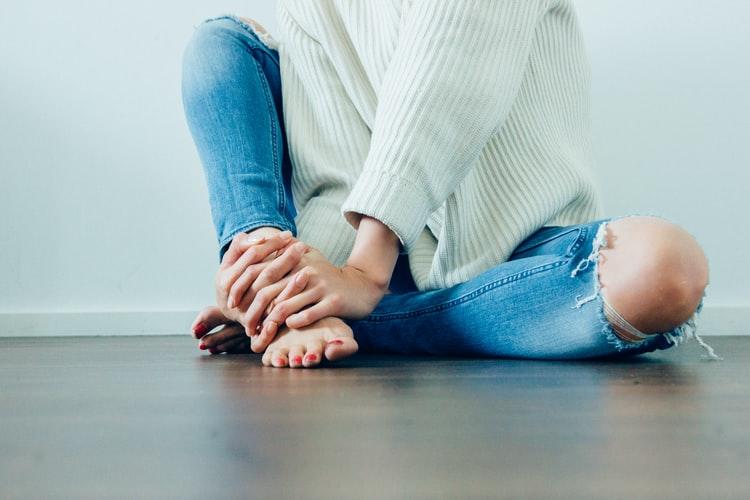 A woman holding the lower part of her leg