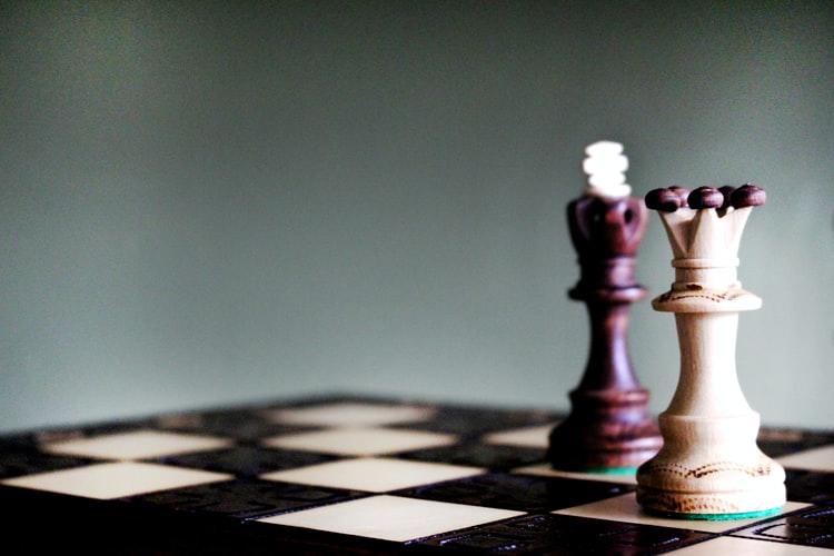 The chess king and queen are set up on the chessboard