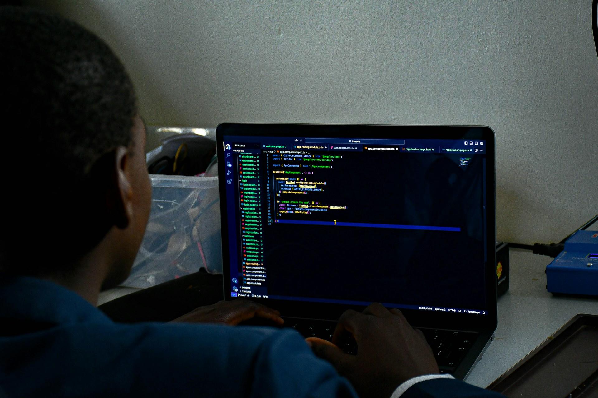 A girl in front of her computer programming