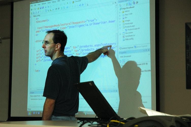 A professor during a computer science class, teaching about computer programming