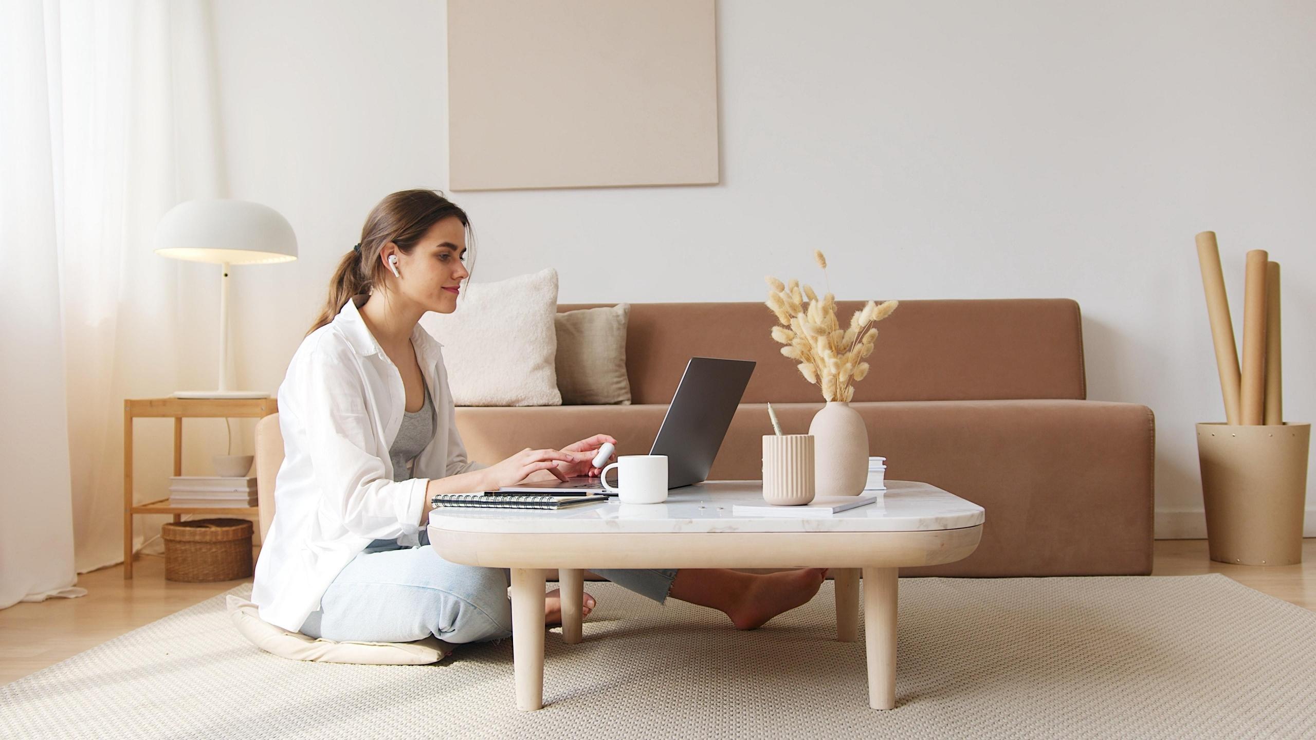 woman using laptop in living room