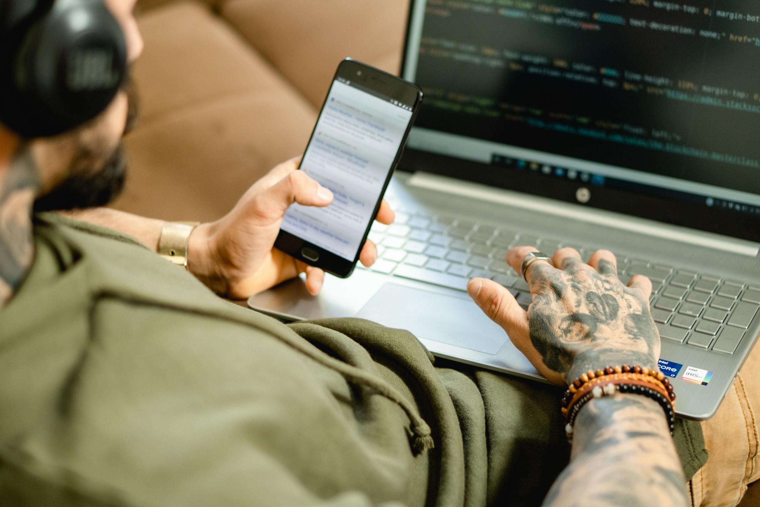 Man on cellphone and laptop