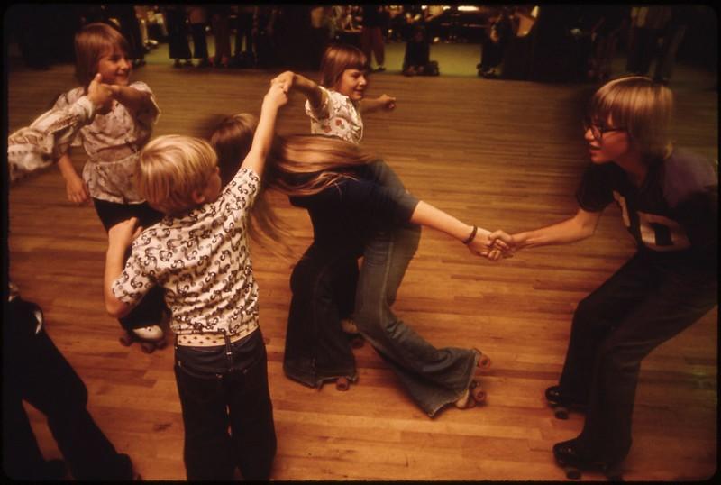 A group of kids enjoys a roller skating session together