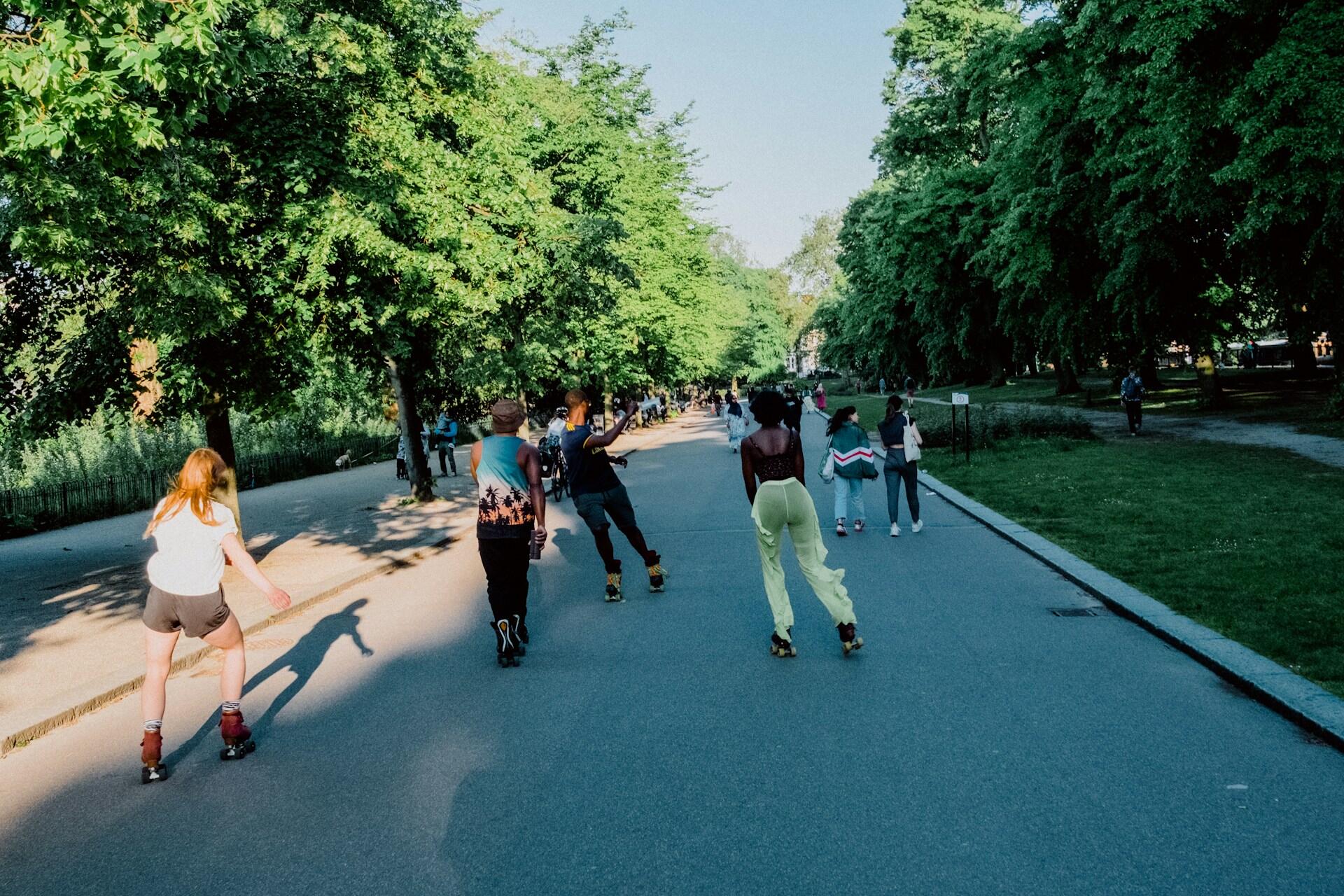 A group of roller skaters practicing outside.