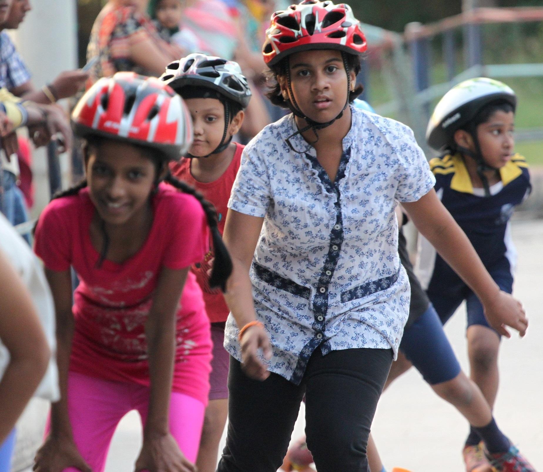 A group of children smiling while roller skating
