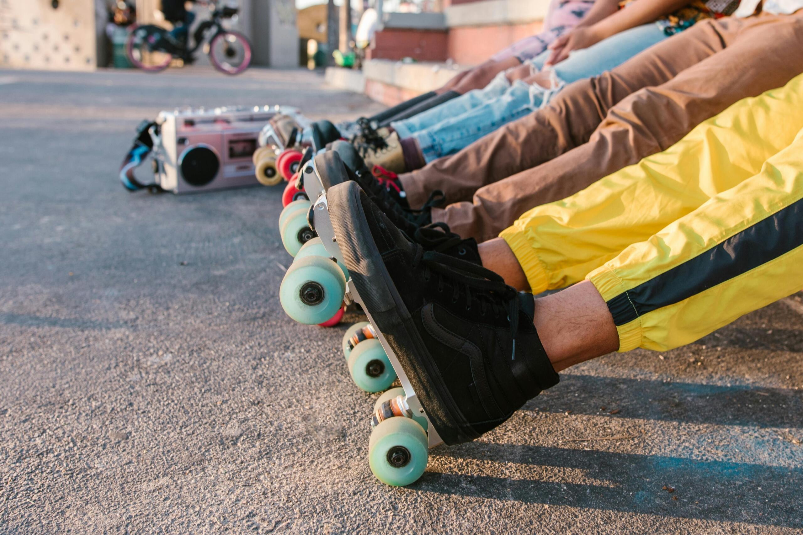 A row of rollerblades neatly lined up on the ground.