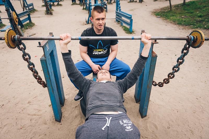 A personal trainer assisting their client during a workout session